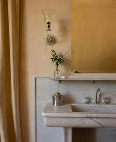 a bathroom with a marble sink and mirror