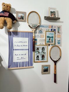 there is a teddy bear, tennis rackets and pictures on the wall next to it