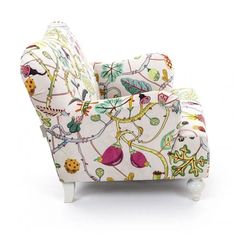 an upholstered chair with colorful designs on the back and arms, sitting against a white background