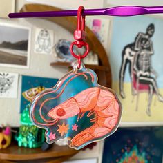 there is a keychain with an image of a fish hanging from it's hook