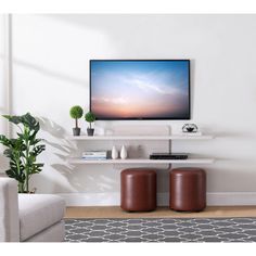 a flat screen tv sitting on top of a white shelf