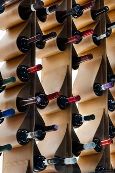 many bottles of wine are lined up on the wall