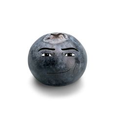 a blue ball with a face drawn on it's side and eyes open, in front of a white background