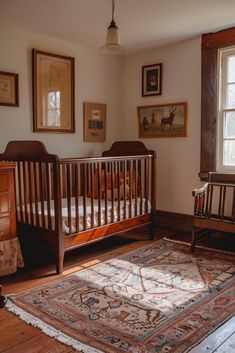 a baby's crib in the corner of a room with pictures on the wall