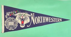 an old north western pennant hanging on the wall in front of a blue background with white lettering