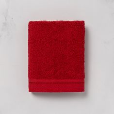 a red towel sitting on top of a white counter