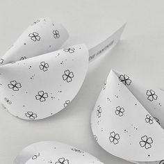 three pieces of paper with black and white flowers on them