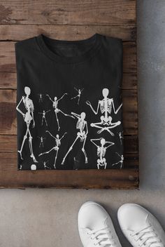 Thanks for stopping by! Skeletons T-shirt Printed on a super soft, cotton tee Dispatched in 5 working days or sooner Unisex Free UK delivery Material: 100% ringspun cotton. Chest (to fit): S  34/36   M  38   L  40/42   XL  44/46   XXL  48/50 ECO-FRIENDLY Each garment is made to order, reducing extra material and energy that would be otherwise wasted We use DTG printing process which is easier on the environment than screen-printing Our ink is bright and also eco-friendly. Do not tumble dry. Wash Punk Style Black Top For Halloween, Spooky Graphic Print Tops For Alternative Fashion, Gothic Tops For Halloween And Alternative Fashion, Halloween Skull Print Tops For Concert, Halloween Skull Print Top For Concert, Emo Cotton Top For Halloween, Spooky Crew Neck Tops For Alternative Fashion, Halloween Concert Skull Print Tops, Grunge Tops For Halloween