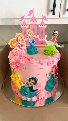 there is a pink cake with princesses on it