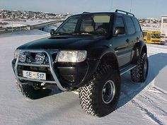 a black suv parked in the snow