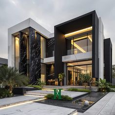 a large modern house with black and white architecture