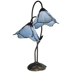 Add gorgeous, classic Tiffany style to your home with this ultra-elegant light lily blue art glass lamp. The two exquisite shades are hand-rolled with each constructed of five stunning petals of warm, colorful glass that complement the sculpted metal, floral base in dark antique bronze finish. This 2-light Dale Tiffany lamp is operated with a convenient in-line switch. Tiffany Lamp, Tiffany Art, Material Things, Blue Lily, Retro Table, Skater Aesthetic, Flower Lamp, Tiffany Glass, Stained Glass Flowers