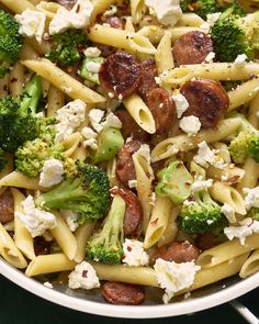 a pasta dish with sausage, broccoli and feta cheese