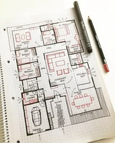 a drawing of a floor plan on top of a notebook