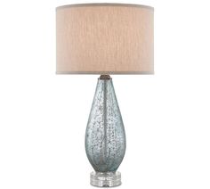 a blue glass lamp with a beige shade