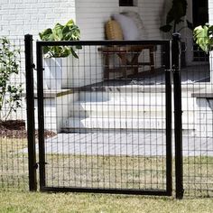 a black gate is in front of a house