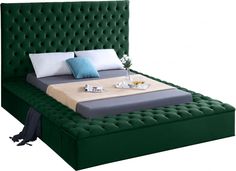 a bed with a green headboard and foot board on it's side, in front of a white background