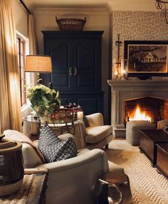 a living room filled with furniture and a fire place in the middle of it's wall