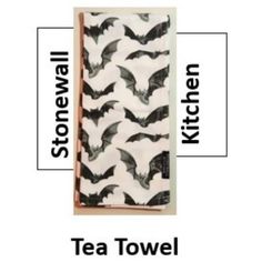 the tea towel has bats on it and is black and white with words above it