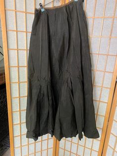 Very cool antique silk skirt with button details. In fair condition, several holes and rips, see all photos! Unfinished waist closureWaist: 27-29”Waist to hem: 30” Black Silk Maxi Skirt For Spring, Black Silk Flared Skirt, Black Pleated Silk Skirt, Fitted Black Silk Maxi Skirt, Fitted Silk Black Maxi Skirt, Gothic Evening Skirt For Spring, Black Vintage Ruffled Skirt, Black Silk Pleated Skirt Bottoms, Black Silk Bottoms With Pleated Skirt