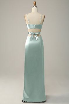 a mannequin wearing a blue dress with a bow at the waist and back