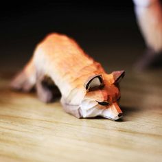 a toy animal laying on top of a wooden floor