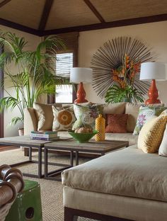 a living room filled with furniture and lots of pillows on top of it's covers