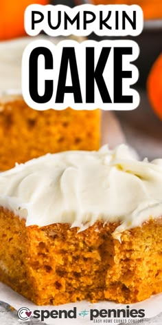 pumpkin cake with white frosting on top sitting on a plate next to oranges