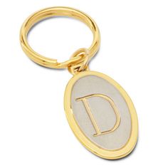 a gold keychain with the letter d on it's front and side