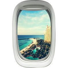 an airplane window looking out at the beach