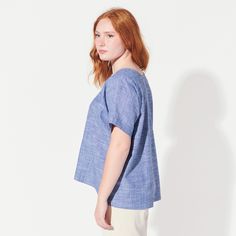 This airy, oversized blouse features two triangle cut-outs at the chest. Made with a lovely light chambray with a bit of stretch (cotton with lycra). Blouse is 23.5" long in front and 27" long in back. Fit is loose. Machine wash and dry.Need a custom length? Just ask!This tee is MADE TO ORDER and ships within TWO WEEKS. SIZE CHART Relaxed Blue Blouse For Spring, Blue Breezy Tops For Spring, Breezy Blue Tops For Spring, Breezy Blue Spring Tops, Chic Light Blue Cotton Blouse, Light Wash Tops For Casual Spring Gatherings, Relaxed Fit Cotton Blouse For Daywear, Casual Oversized Light Blue Blouse, Breezy Short Sleeve Cotton Blouse