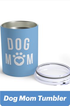 a blue dog mom tumbler next to a glass container with the lid down and an image of a dog's paw on it