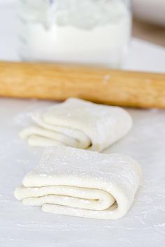 rolled up dough sitting on top of a table