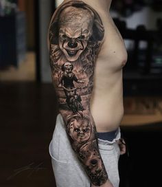 a man's half sleeve with an evil clown and other characters on the arm