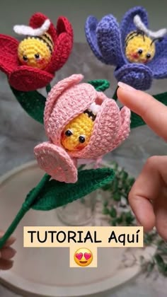 three crocheted flowers are being held up by someone's hand with the words,