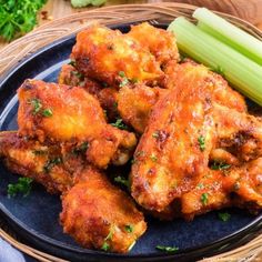 chicken wings with celery on a black plate