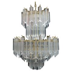 the chandelier is made from glass and has gold trimmings on it