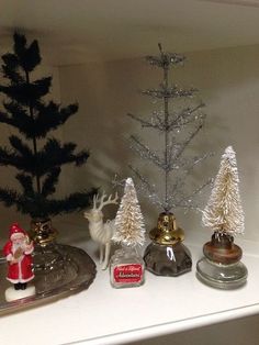 small christmas trees and other ornaments on a shelf