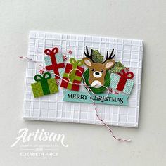 a christmas card with reindeer and presents on the front, and merry christmas tag in the back