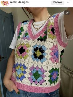 a woman wearing a colorful crocheted vest