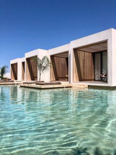 an empty swimming pool with lounge chairs next to it