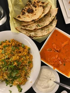 several plates of food on a table with sauces and napkins next to them