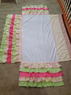 an image of a bed spread with ruffles on the bottom, and pink trim around the edges