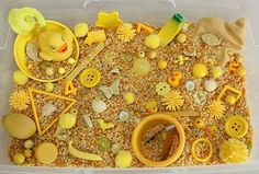 a plastic container filled with lots of different toys and materials on top of it's surface