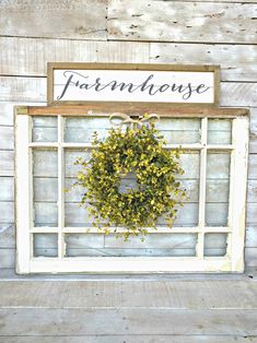 an old window is decorated with a wreath and the words farmhouse house are written on it