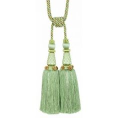 two green tassels hanging from a rope