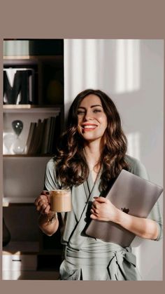 a woman holding a coffee cup and laptop