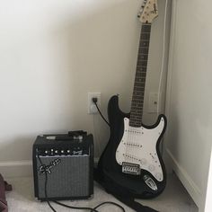 an electric guitar and amp sitting on the floor