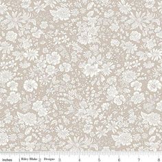 a white and beige floral wallpaper with lots of flowers on the bottom half of it