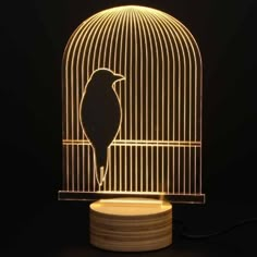 a bird in a cage that is lit up with the light on it's side